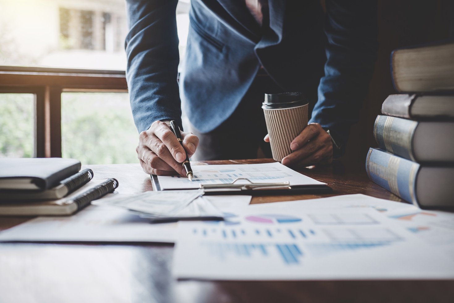 Businessman Pointing at Graph and Chart 